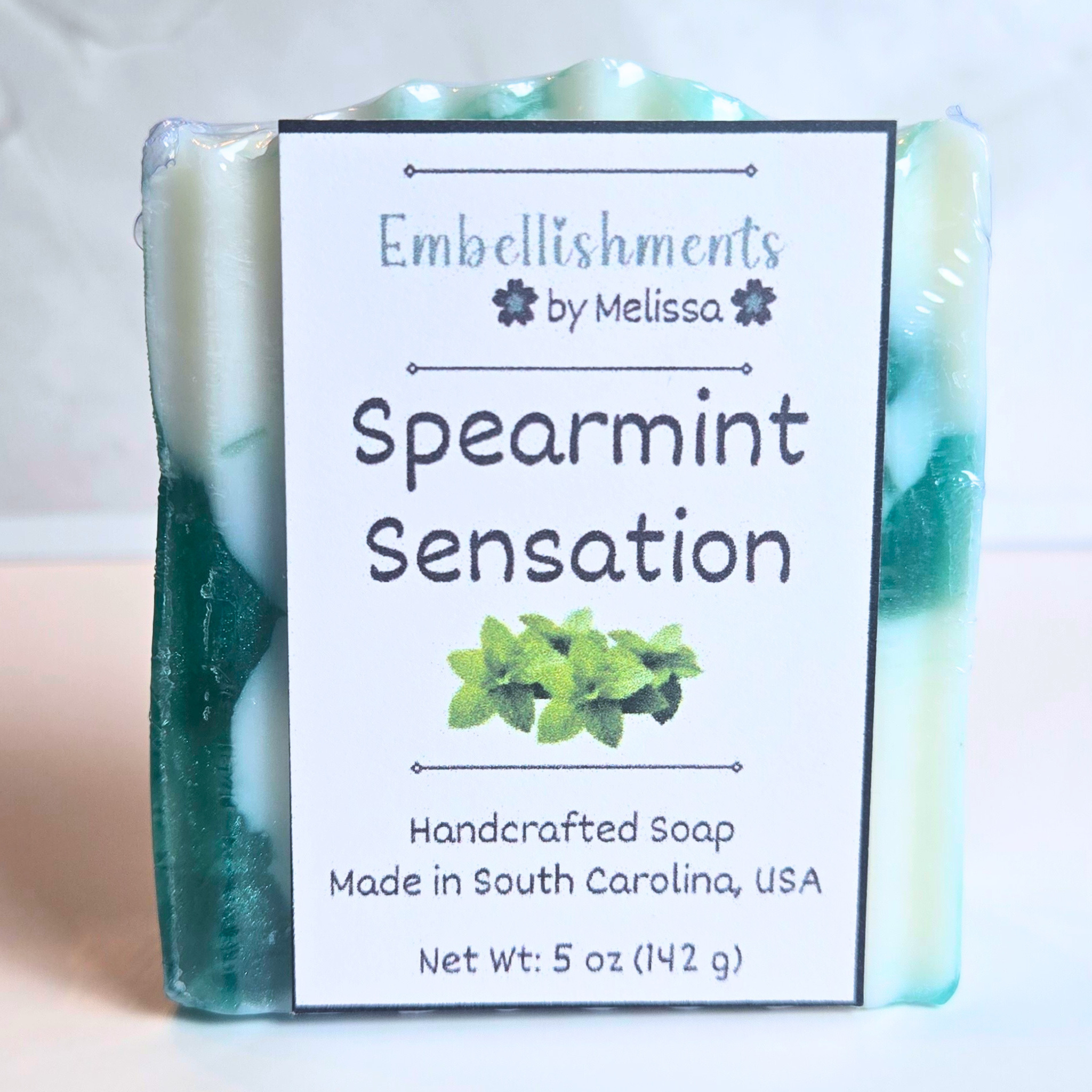Refreshing spearmint-scented artisan soap with marble swirl pattern, front view.
