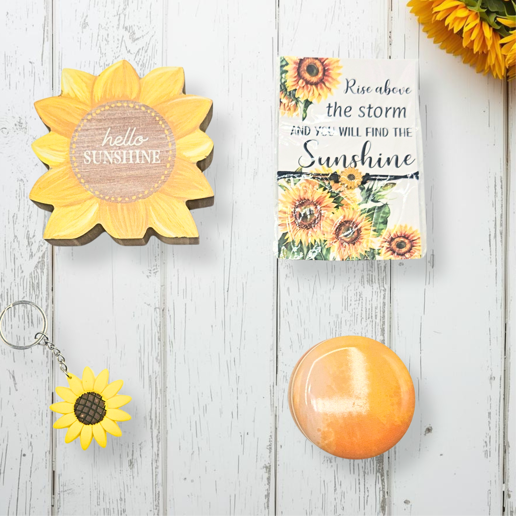 Decorative items with sunflower designs on a wooden surface