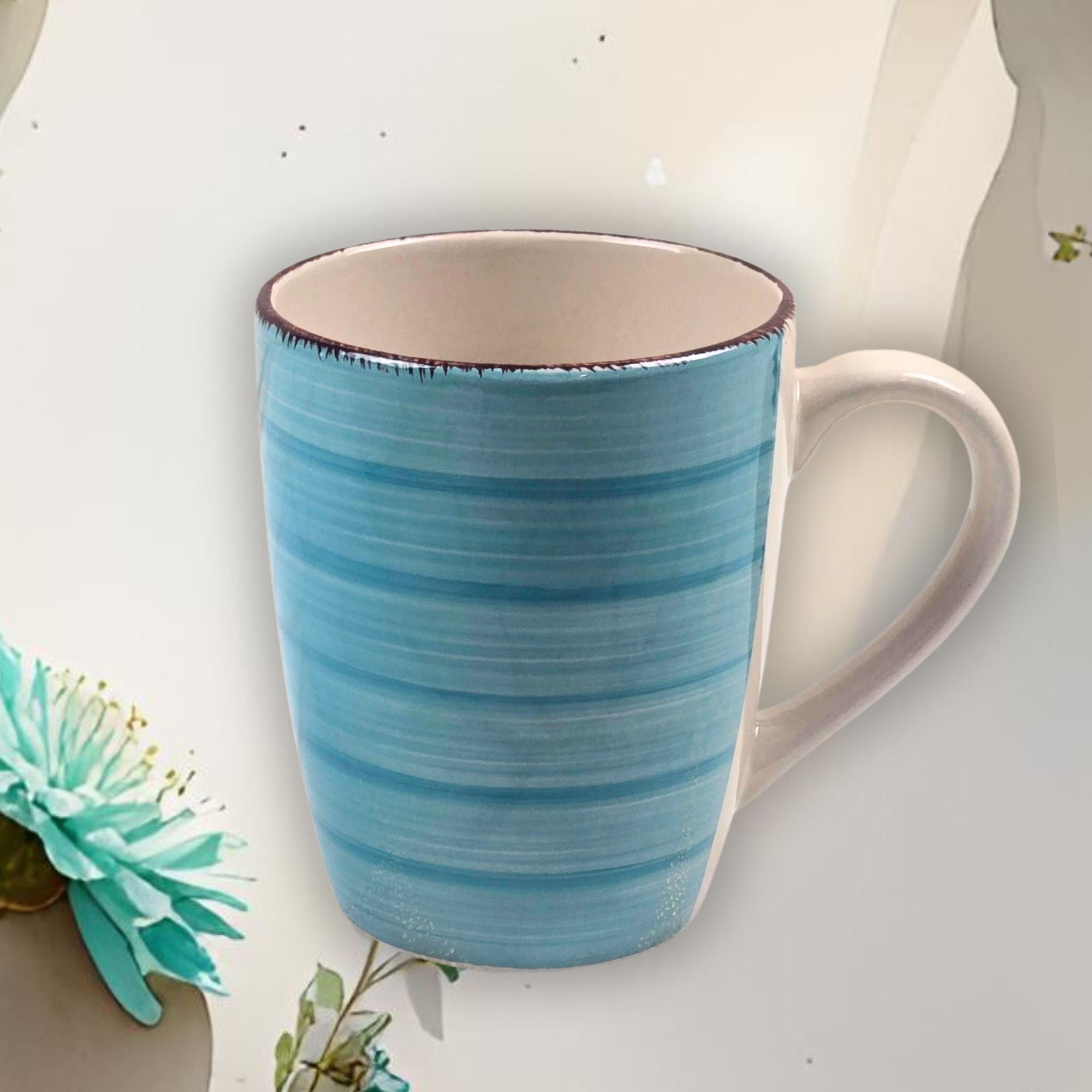 Teal ceramic mug with a white interior on a light background.
