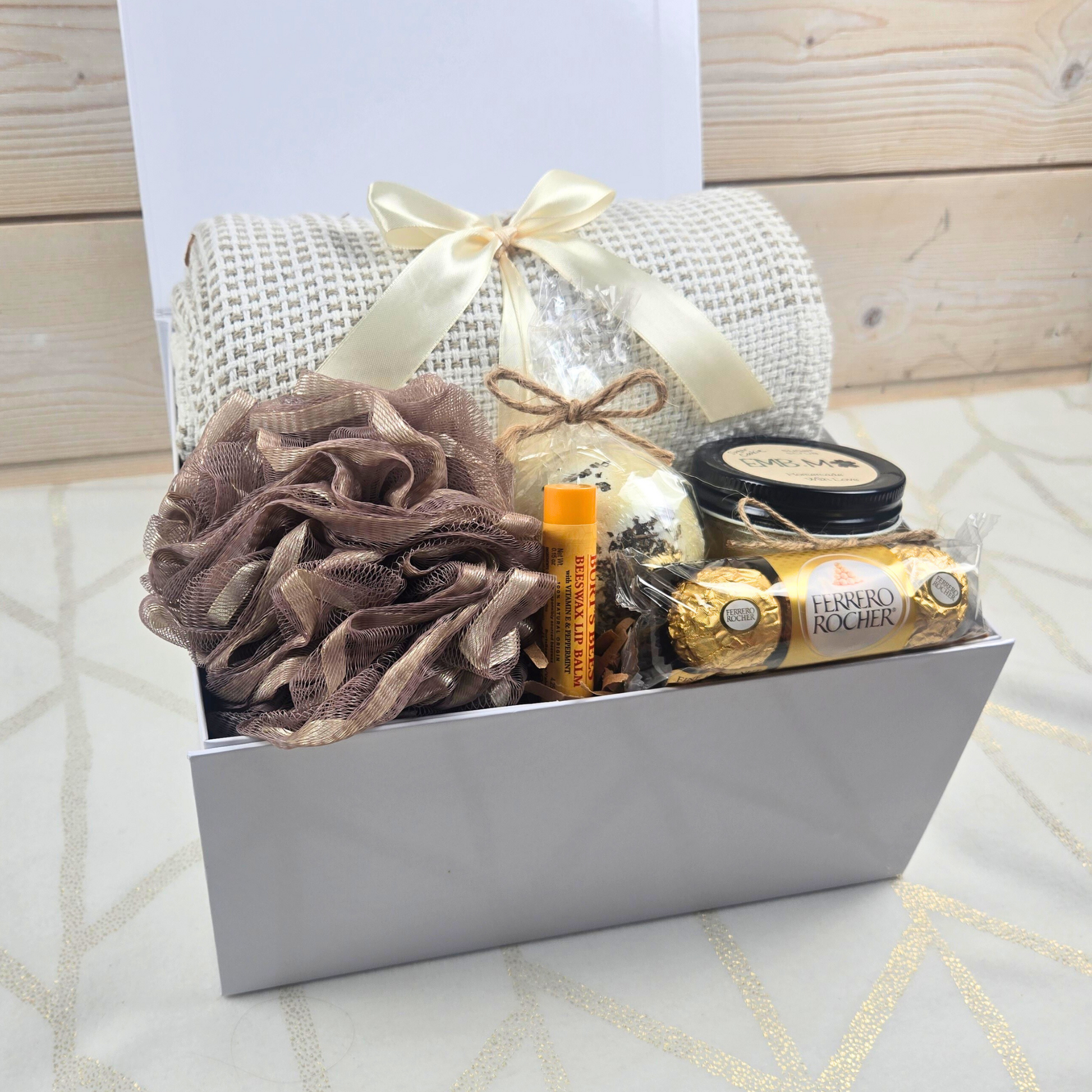 Birthday gift box for her with throw, bath pouf, bath bomb, lip balm, sugar scrub and chocolates.