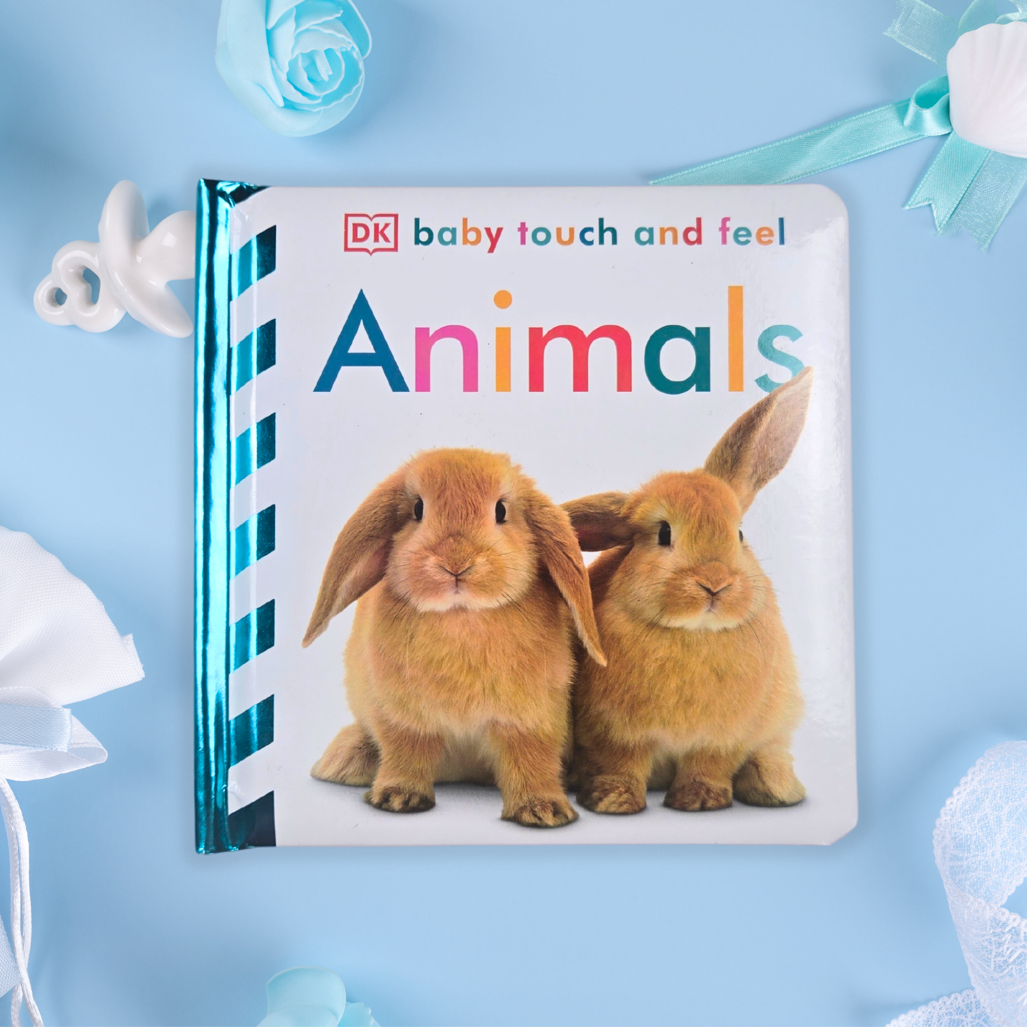 Touch-and-feel book for babies with textured animal illustrations, included in curated gift box, front view.