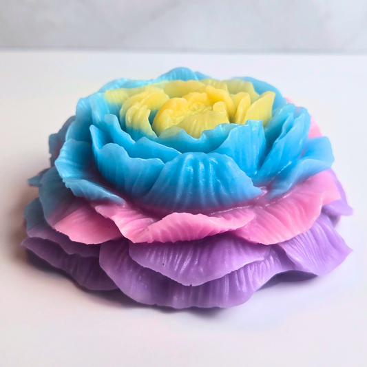 Handcrafted unicorn fruit blossom soap with a swirl of pastel colors, front view.