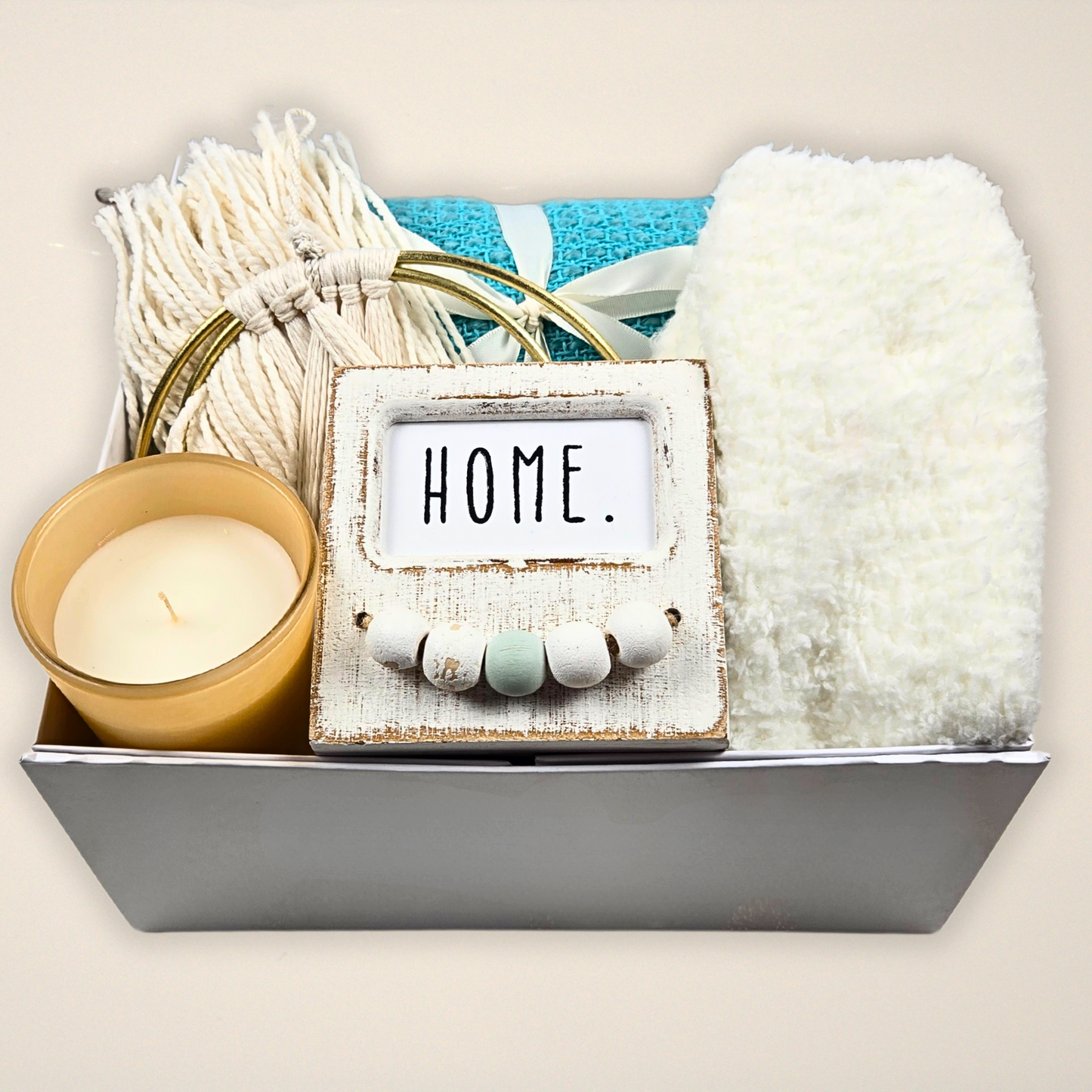 Boho-style gift box for her with decor, throw, fuzzy socks and candle.