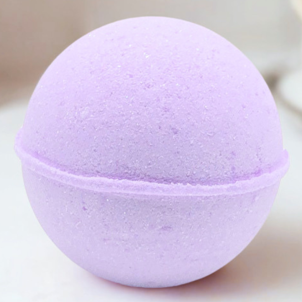A round lavender bath bomb with a textured, porous surface, shown in a close-up shot against a soft, light beige background.