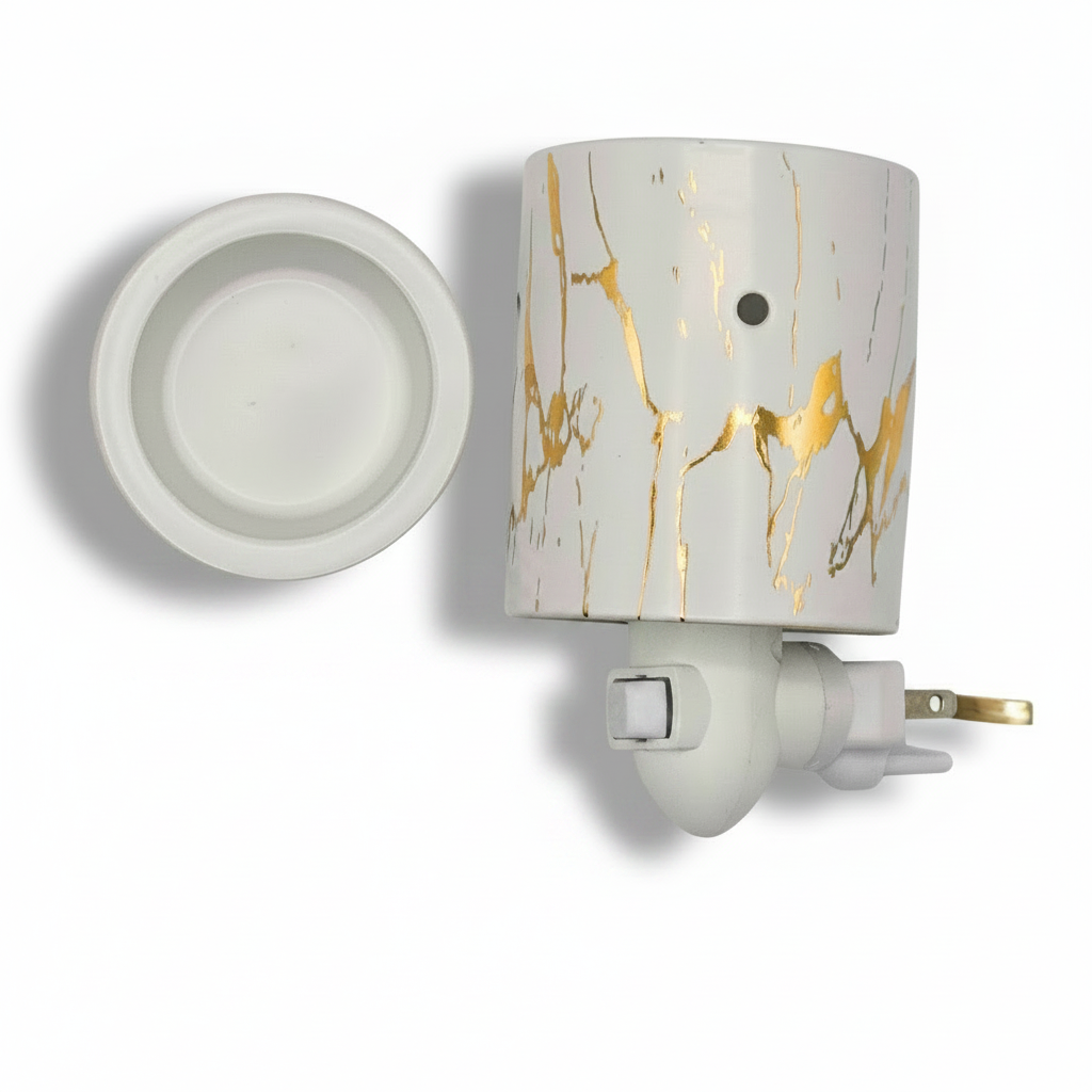 A white ceramic electric wax warmer with a gold marble pattern on the body, shown with its white ceramic lid placed to the left and its white plug and cord visible at the bottom right, set against a plain white background.