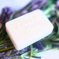 Lavender-scented soap with white kaolin clay, styled for wedding gift table, side view.