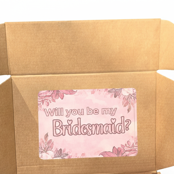 Card inside a box with 'Will you be my Bridesmaid?' text on a floral background