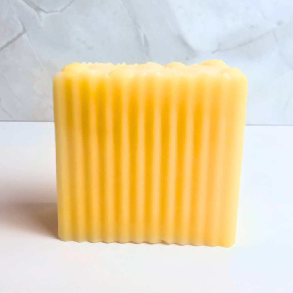 Yellow soap bar with zesty lemon aroma, aemrtisan-made, front view.