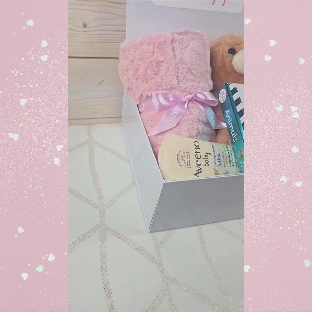 Complete baby girl gift box featuring plush toy, book, blanket, and lotion, video.